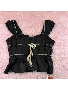 Cider Black and white babydoll top with ruffles and tie detail.